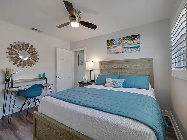 2nd guest bedroom with queen bed and Samsung Smart TV and desk.