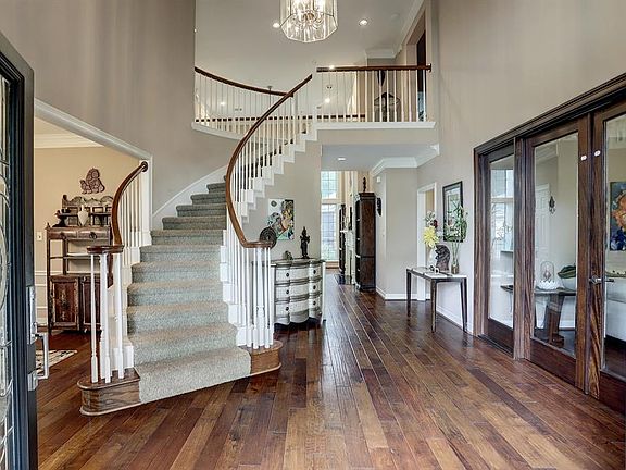 Open the gorgeous leaded double doors and walk into this dramatic two-story entry.