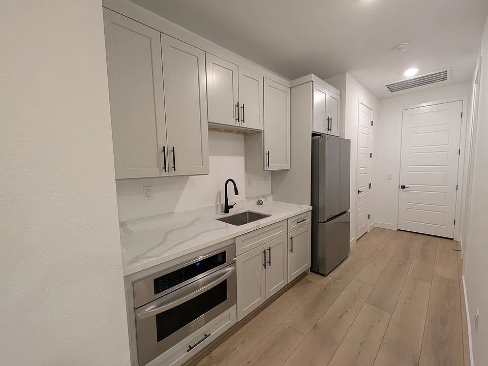 Kitchenette with new stainless steel appliances and quartz countertop