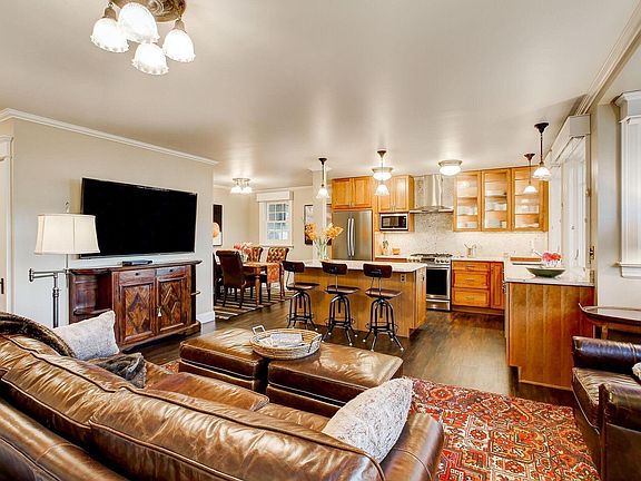 Living room, kitchen and dining area. Private laundry room and storage/pantry shelves entered via door on left.