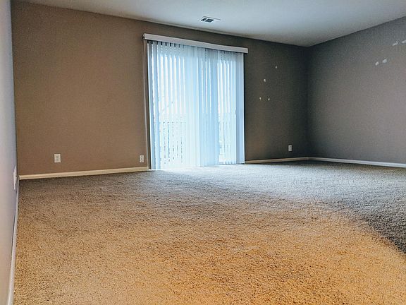 Spacious living room with balcony. (This particular apartmen