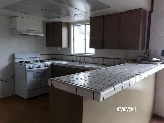 KITCHEN, BREAKFAXT BAR, AND NEW STOVE AND DISHWASHER.
