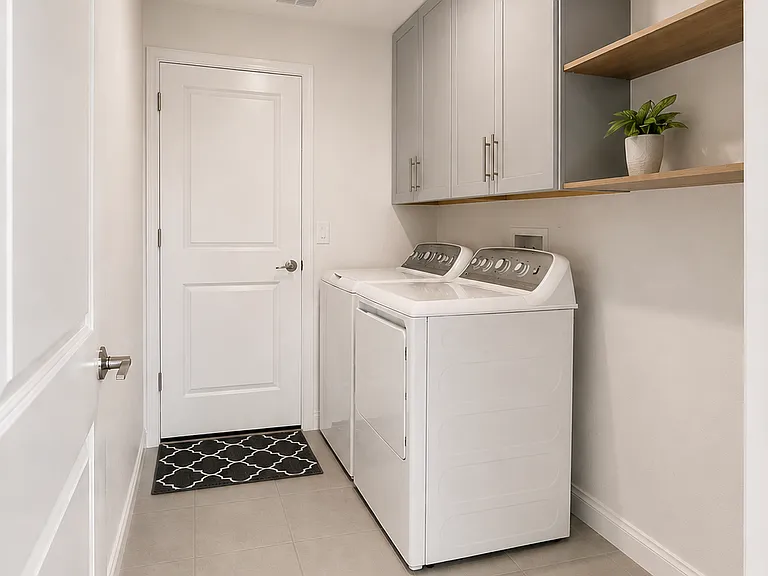Laundry room with connection to garage