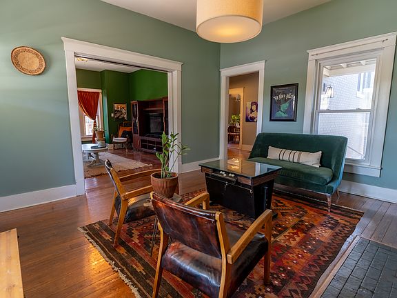 One of two living areas with fireplace and built-in bookshelves.