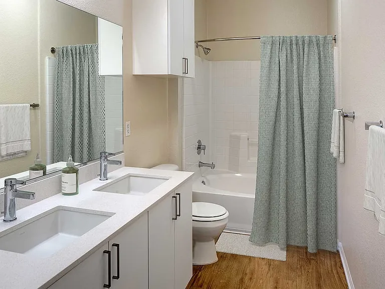 Renovated Package II bathroom featuring white cabinetry, white quartz countertops, and hard surface flooring