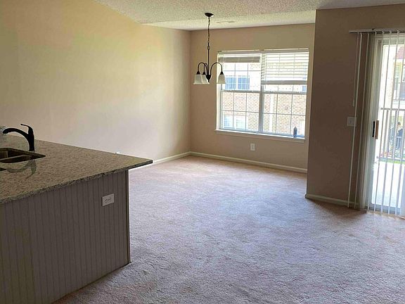 Dining area and kitchen counter with bar seating.