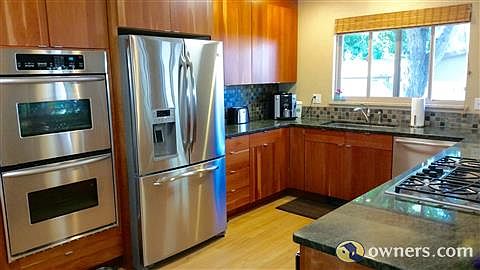 Custom cherry cabinets, gas cooktop, granite countertops