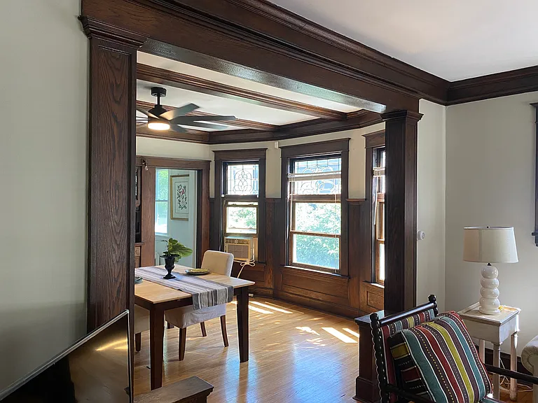 Living room into dining room framed in original woodwork.