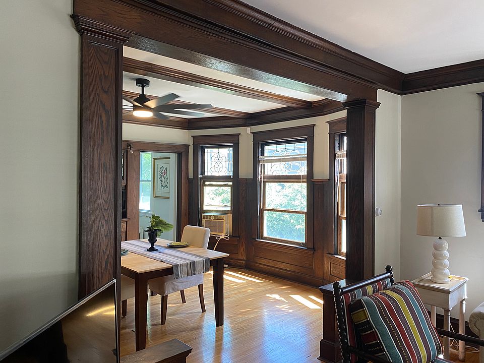 Living room into dining room framed in original woodwork.