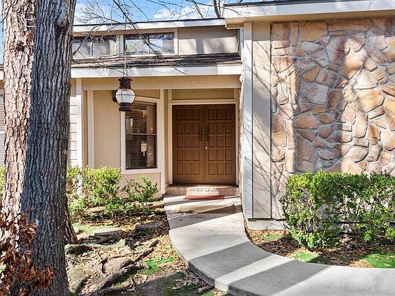Greet guests under this covered front porch with double doors