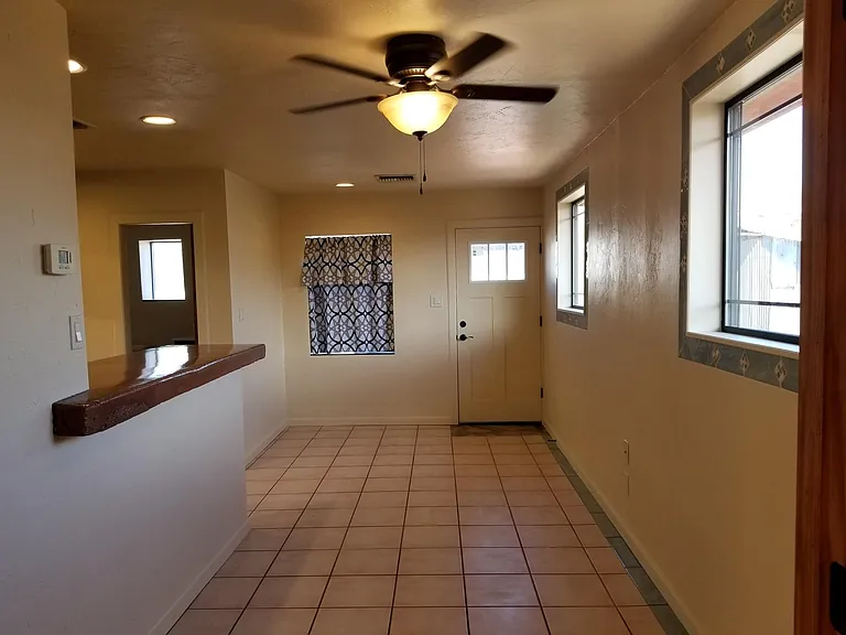 Open living area with kitchen, bar and small eating cove.