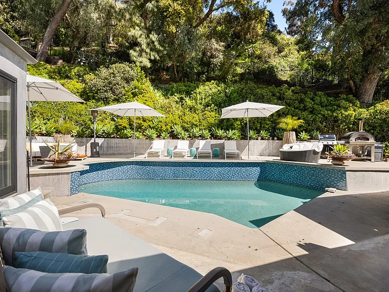 Lush green surroundings provide a picturesque backdrop to the outdoor retreat.