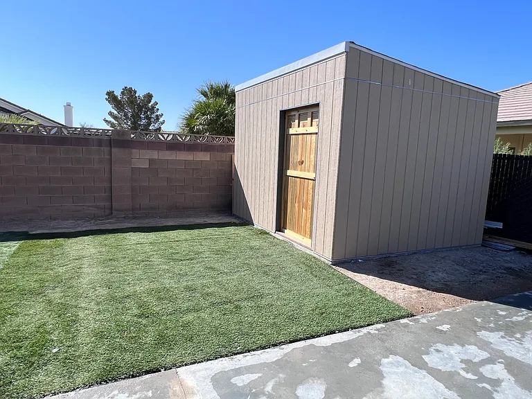 12 x 10 extra storage shed and artificial turf for low maintenance landscape and water savings.