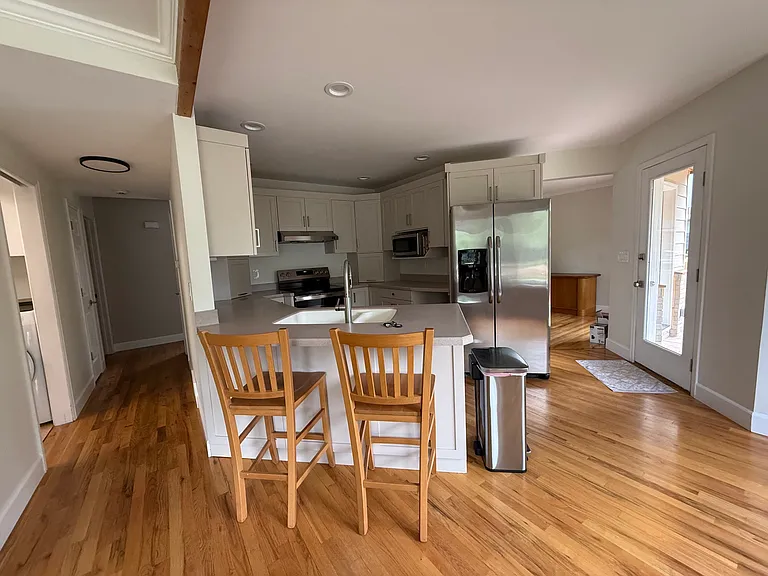 Kitchen with stainless appliances and new cabinet doors