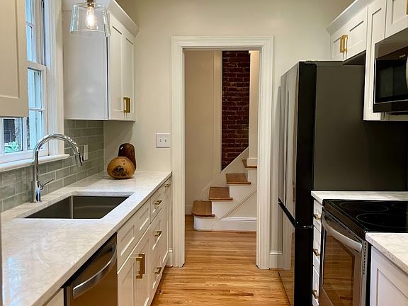 New kitchen with quartz counter tops, hardwoods, full size fridge, oven, dishwasher and microwave.