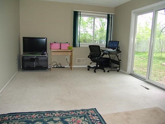 First floor family room off the kitchen has a sliding glass door to the back yard and a door to the 