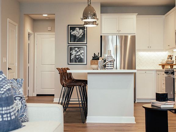 An image of the kitchen and island in the Citrus Plan 4 Model Home at New Haven.
