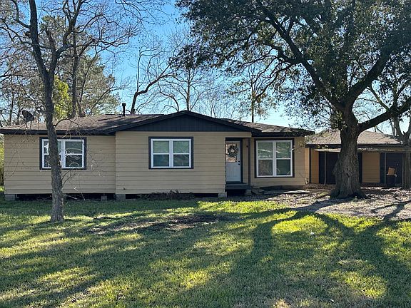 Newly remodeled home with new windows, sitting on a large partially fenced yard