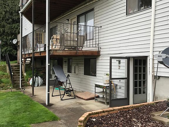 The open screen door is the entrance into the unit.