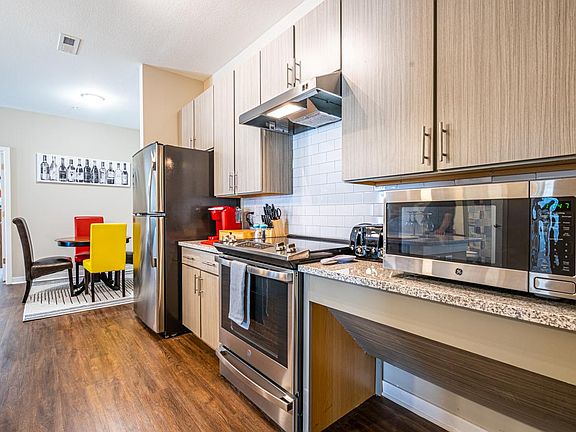 Stainless steel appliances welcome your culinary skills and delights. Space below counters allows movement and better cabinet accessibility for wheelchairs.