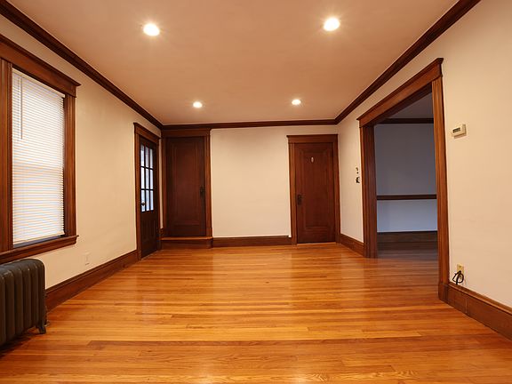 Looking from the D wall side to the B wall where there are two doors: the right one is the entry door open to the front stairway landing, the left one opens to the attic stairway.