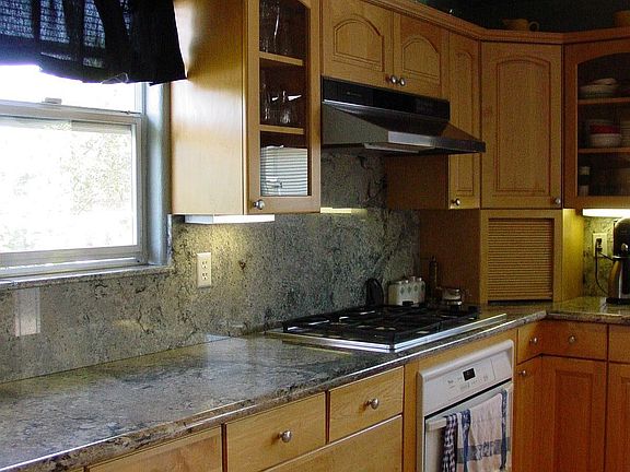 Granite counters in Gourmet kitchen with Broan gas cooktop, many more upgrades