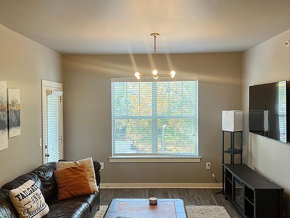 fully furnished living room with TV installed