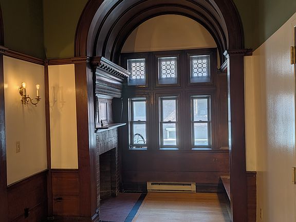 Entryway and office nook with decorative fireplace