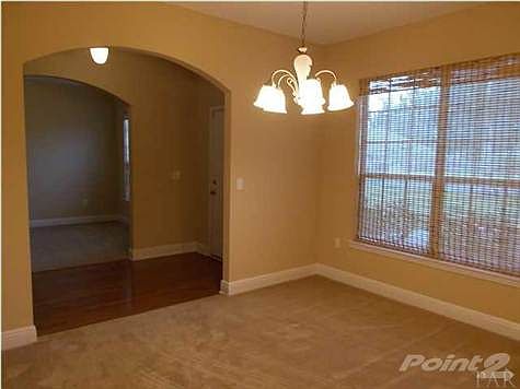 Formal Dining view into Study through arched entryways.