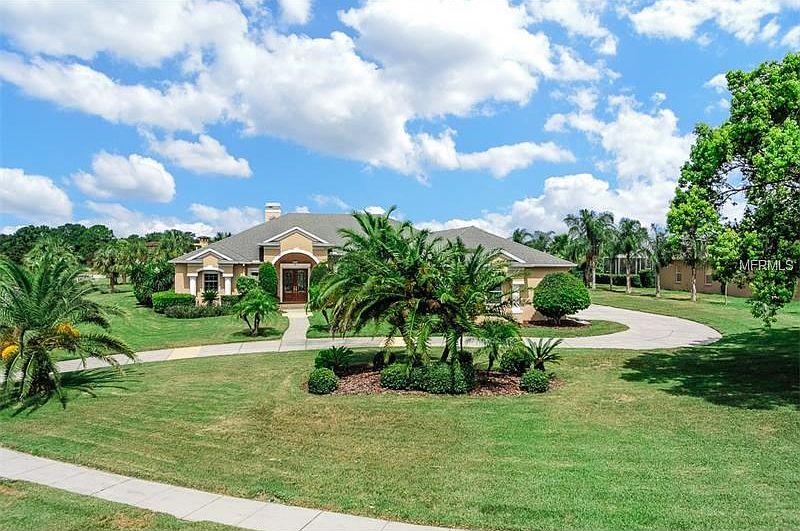 Block construction, double paned windows, side entry 3 car garage, hurricane shutters, no flood insurance on .8 acres.