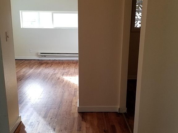 Entry way with bathroom directly to the right, kitchen through the archway and living room straight ahead.