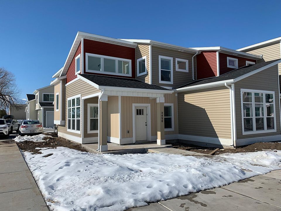 End unit with 2 car garage. Small outdoor patio in front yard.