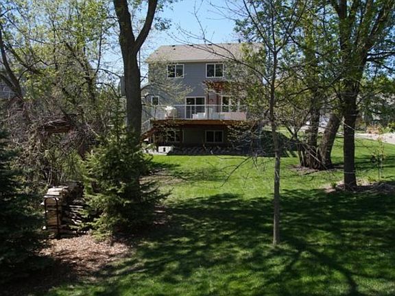 View of dining area includes from living room. Patio door leads to large deck over looking large back yard.