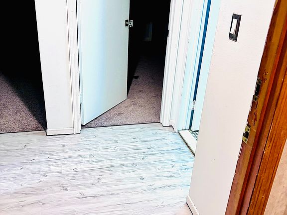 Entry (bedroom ahead, bath to right, living room & kitchen to the left.