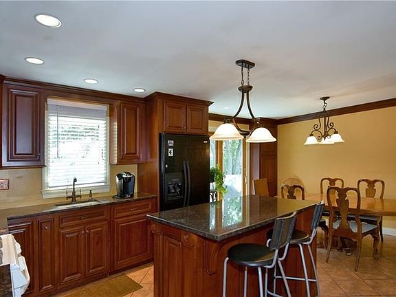The kitchen is further enhanced with beautiful granite counters plus soft-close cherry cabinetry.