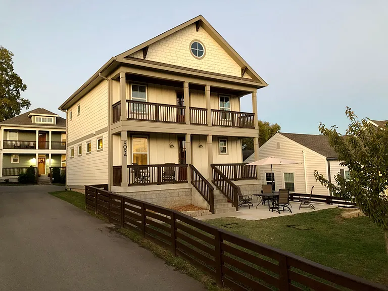 Single-family home with fence in front & porch for entertaining