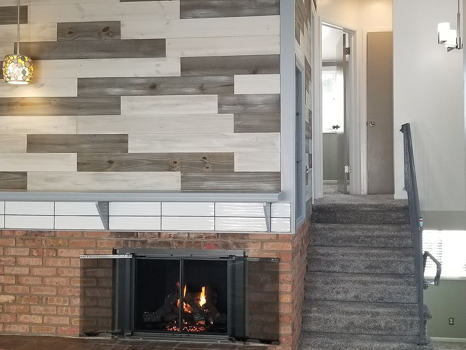 Main living area, stairs to upper level, and barnwood shiplap accents.