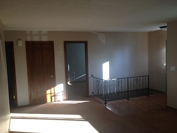 Living room with stairs to lower level family room, garage