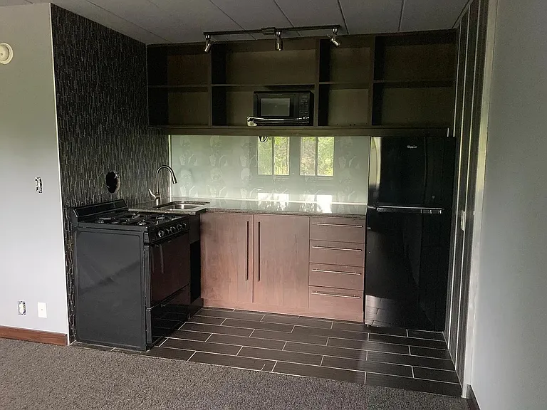 Elevate your living experience at LS Capital Group with this sleek, modern kitchen featuring high-end appliances, stylish cabinetry, and ample natural light. Perfect for culinary enthusiasts. Schedule a tour today to see it for yourself!