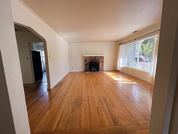 Hardwood floors, wood-burning fireplace, large picture window