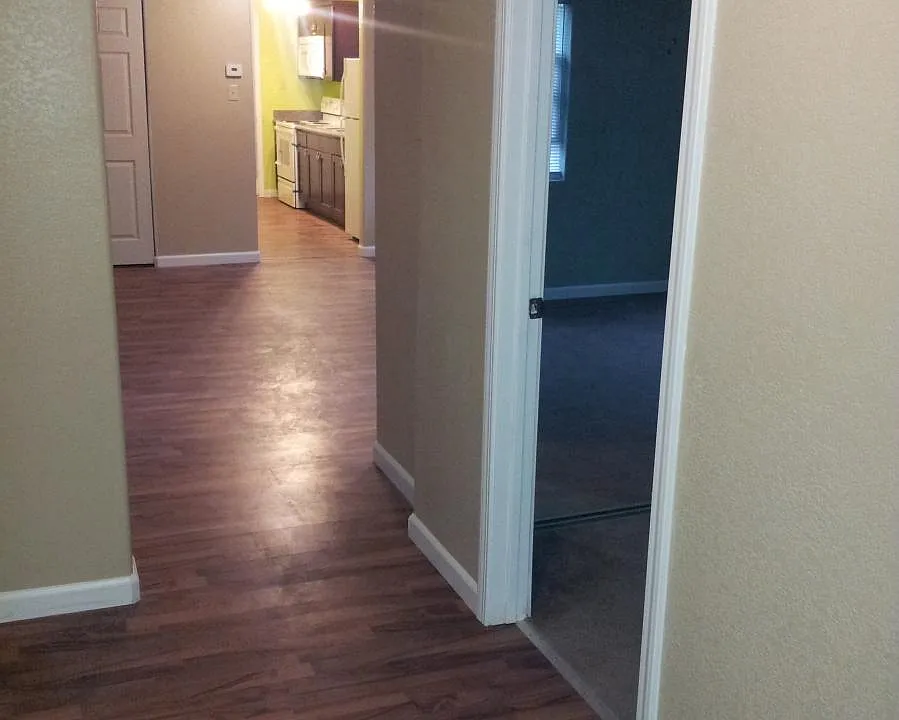 hall way, bedroom to right, kitchen past living/dinning