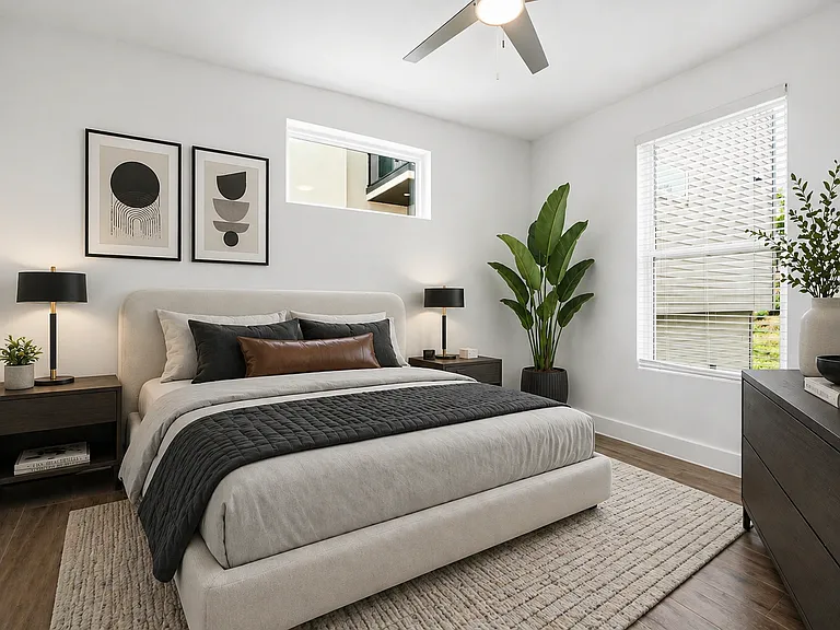 Bright 2nd bedroom featuring wood- look tile finish flooring, a ceiling fan, a large window with blinds, and a transom window