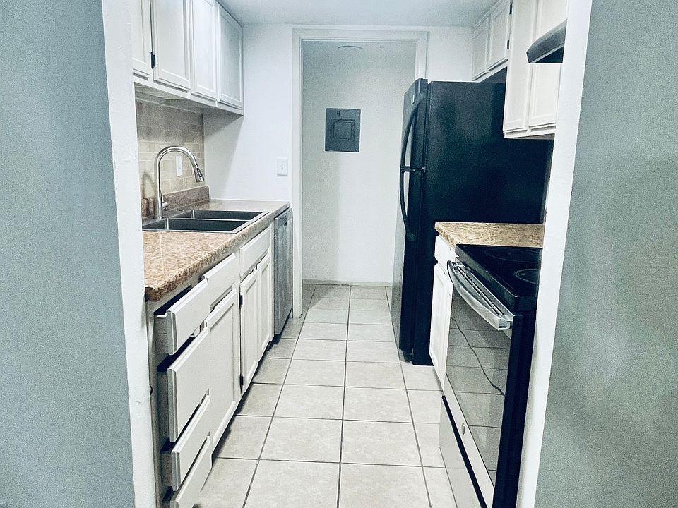 Cozy kitchen with the laundry and storage area just beyond.