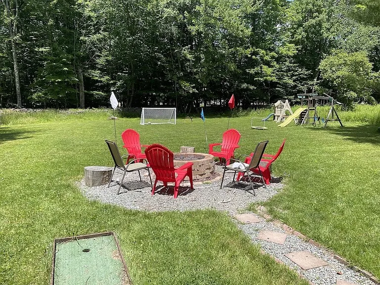 large flat backyard with fire pit