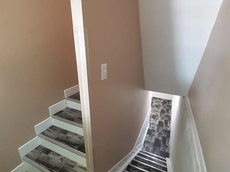 Well-lit basement Laundry room with extra storage.