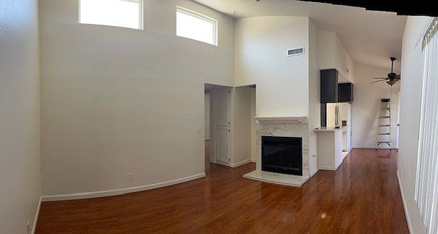 View from entry. Living to the left. Kitchen and Dining Nook with Balcony forward right,