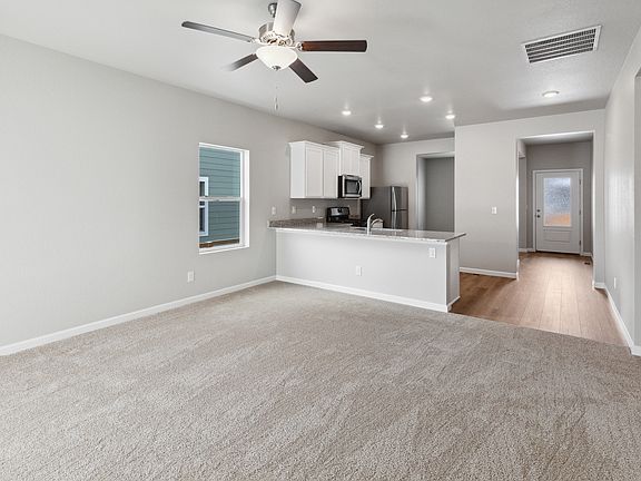 Open layout with the kitchen overlooking the large living room.