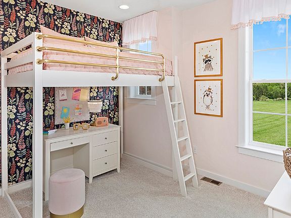 Secondary bedroom with large window in a DRB Homes Whitaker II model home.