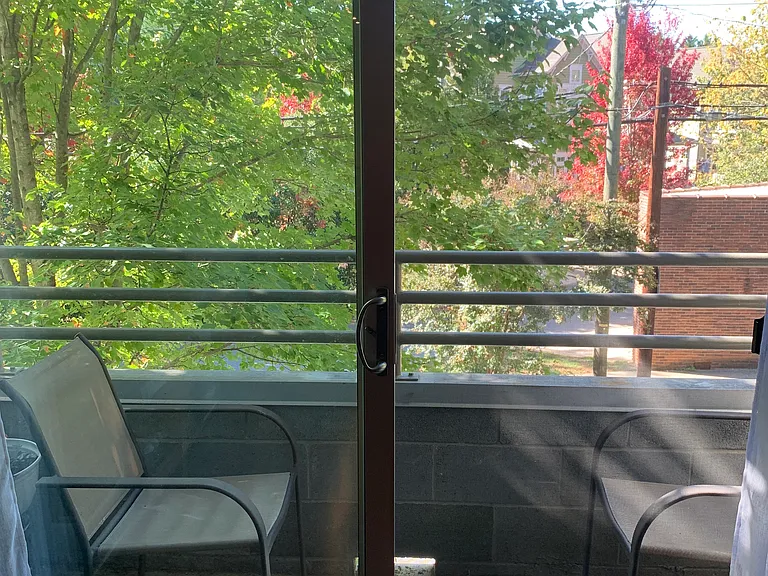 From the living room looking out through the sliding glass door and onto the back balcony