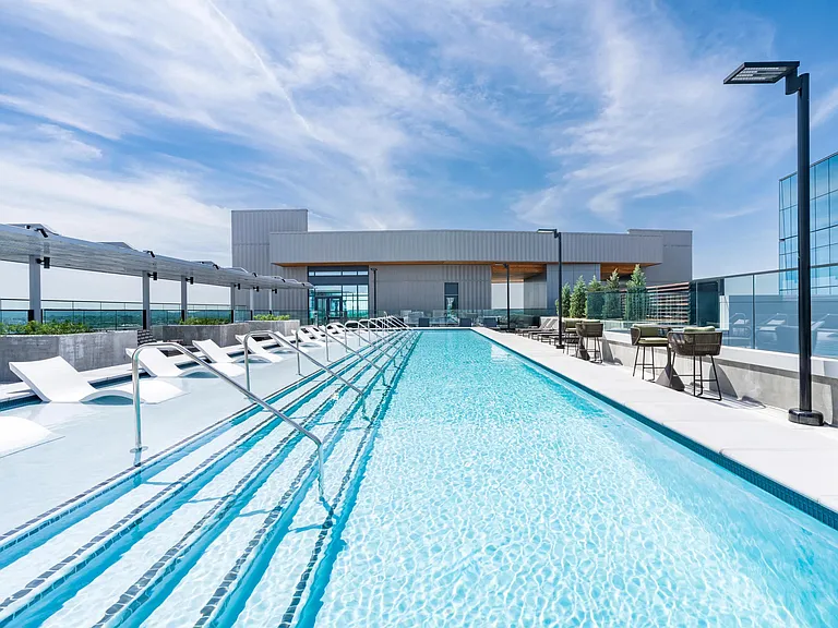 McGavock's rooftop pool with crisp sightlines, in-water loungers, and open-air seating creates a refined setting for daytime relaxation and skyline views.
